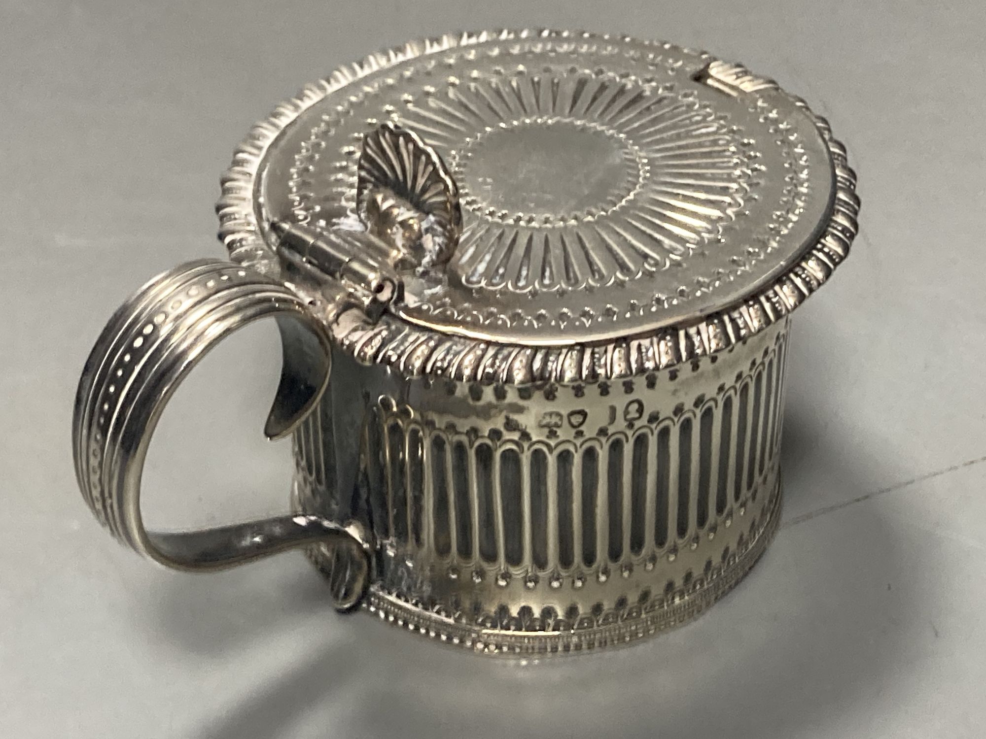 A George IV silver drum mustard, with blue glass liner, Emes & Barnard, London,1824, height 6.7cm, 145 grams.
